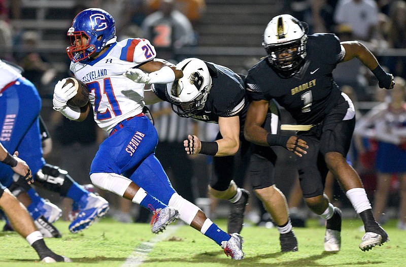 Cleveland's Keegan Jones (21) gets past two Bradley Central players during a game at Bradley in September 2017. After enrolling at Navy this past summer before asking to transfer, Jones signed as a receiver Wednesday with UCLA.