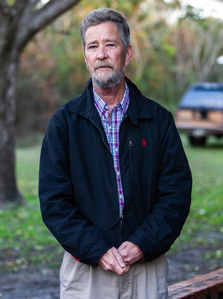 In this Dec. 5, 2018, file photo, Leslie McCrae Dowless Jr., poses for a portrait outside his home in Bladenboro, N.C. State investigators have described Dowless as a "person of interest" in their probe into 2018 voting irregularities involving absentee ballots. (Travis Long/The News & Observer via AP, File)