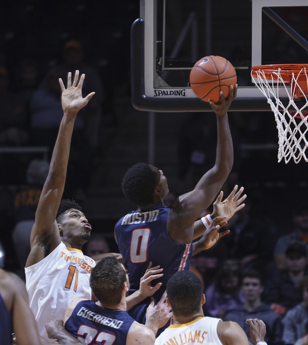 Tennessee's Kyle Alexander, left, can only watch as Samford's Brandon Austin drives to the basket for two points during the first half of Wednesday night's game in Knoxville.