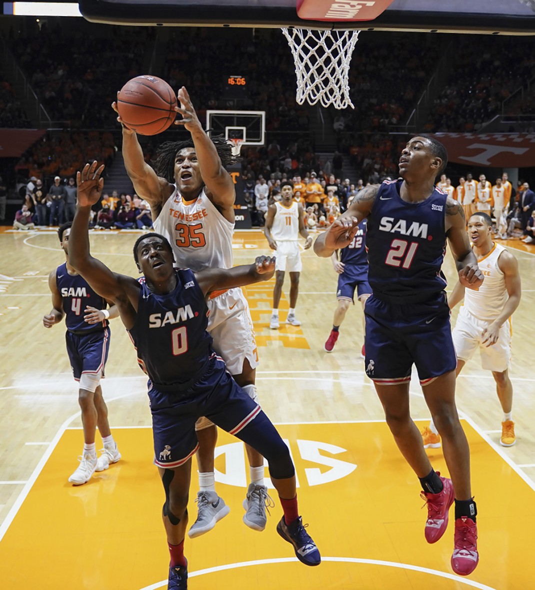 Tennessee's Yves Pons grabs a rebound over Samford's Brandon Austin on Wednesday night in Knoxville. The visiting Bulldogs had won three straight games entering the matchup.