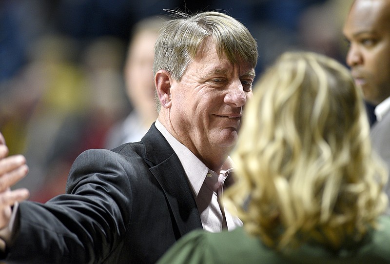 N.C. State women's basketball coach Wes Moore, a former UTC coach, greets his former player and assistant coach Katie Burrows before Friday night's game at McKenzie Arena. Burrows is in her first season as UTC's coach.