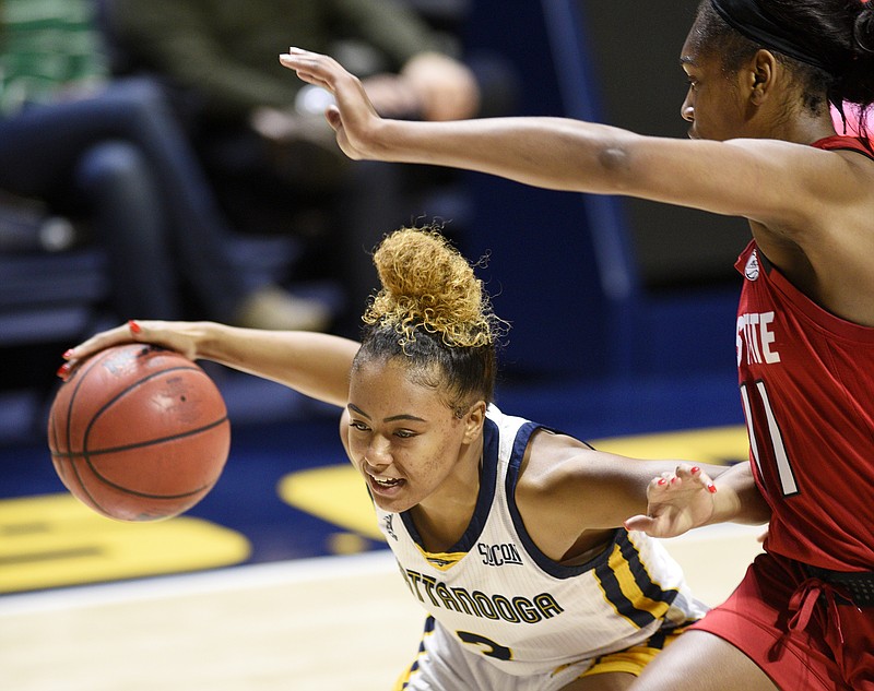 UTC's Mya Long, with ball, tries to get past North Carolina State's Kiara Leslie during their teams' Dec. 21 game at McKenzie Arena.
