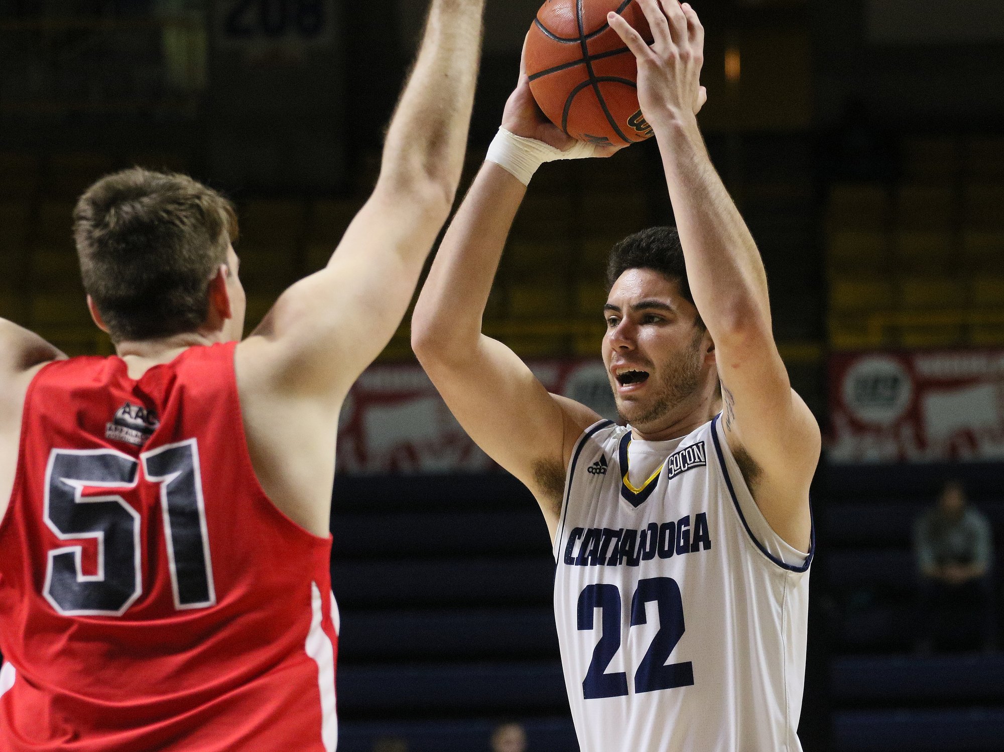 Bryan College's Justin Warner (51) puts pressure on UTC's Keigan Kerby as he looks for an open teammate during Friday afternoon's game at McKenzie Arena.