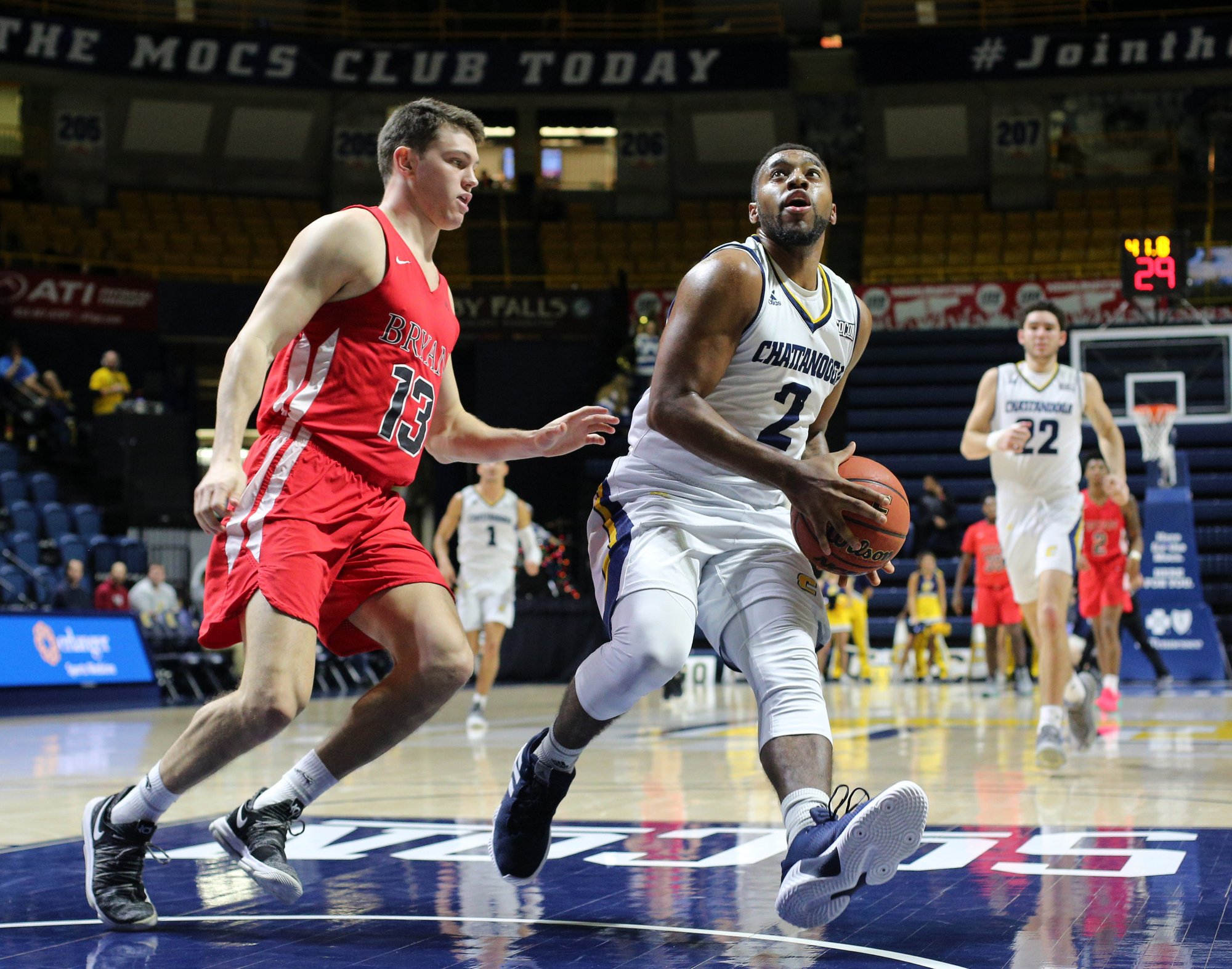 Bryan College's Keaton Dotson (13) puts pressure on University of Tennessee at Chattanooga's Jerry Johnson Jr. (2) looks to put up a shot during the UTC vs. Bryan College boys basketball game Friday, December 21, 2018 at McKenzie Arena in Chattanooga, Tennessee.