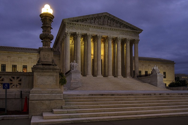 In this Oct. 5, 2018 photo the U. S. Supreme Court building stands quietly before dawn in Washington. The Supreme Court won't let the Trump administration begin enforcing a ban on asylum for any immigrants who illegally cross the U.S.-Mexico border. New Justice Brett Kavanaugh and three other conservative justices sided with the administration. The court's order Friday leaves in place lower court rulings that blocked President Donald Trump's proclamation in November automatically denying asylum to people who enter the country from Mexico without going through official border crossings. (AP Photo/J. David Ake)


