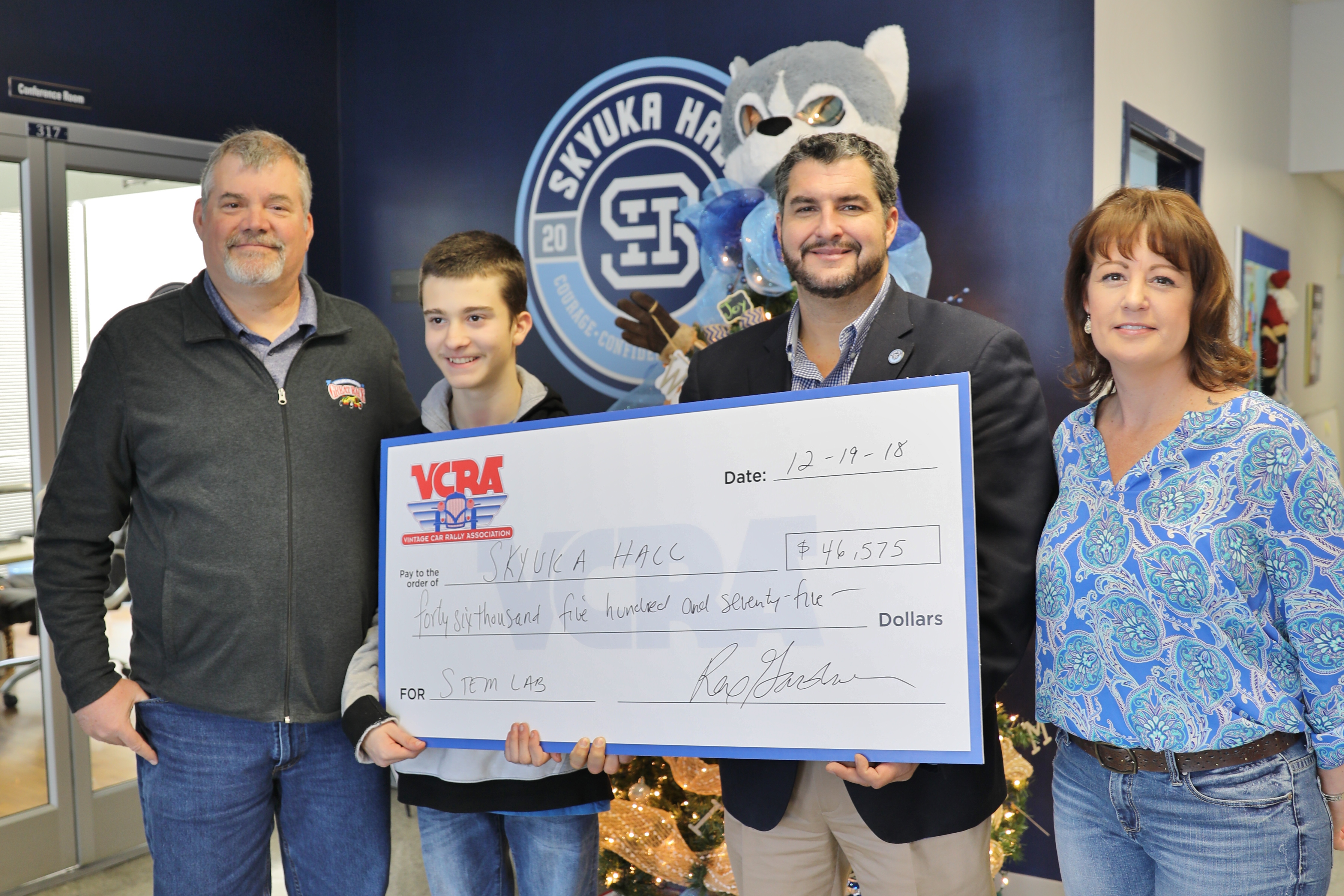 Skyuka Hall accepts $46,575 from the Vintage Car Rally Association on Dec. 19, 2018, to start STEM Labs at the school. Pictured from the left: Jeff Stumb, parent; Hudson Stumb, son and student; Josh Yother, head of school; Melanie Covert, assistant principal. Contributed Photo/Times Free Press