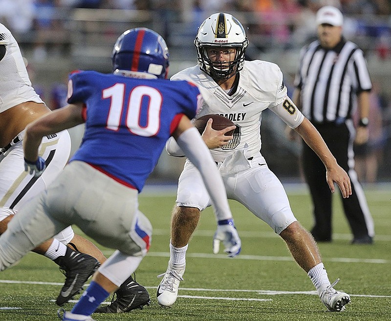 Bradley Central quarterback Dylan Standifer tries to evade Cleveland's Jake Applegate (10) during their game in September. Standifer was named to the TSWA Class 6A all-state football team.