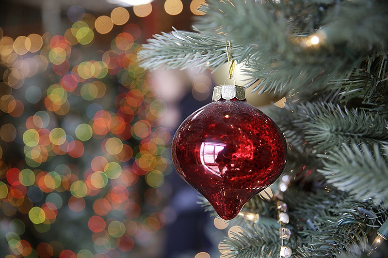 An ornament hangs on an artificial Christmas tree at the Balsam Hill Outlet store in Burlingame, Calif., on Nov. 30, 2018.