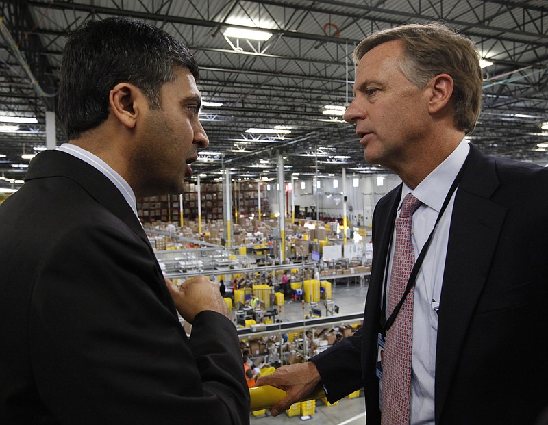 Staff Photo by Doug Strickland/Chattanooga Times Free Press - February 02, 2012.  Sanjay Shah, the general manager of Amazon's new Chattanooga fulfillment center, left, talks with Governor Bill Haslam during a tour of the facility.  Thursday marked the grand opening ceremony of the center, which is located in Enterprise South Industrial Park.
