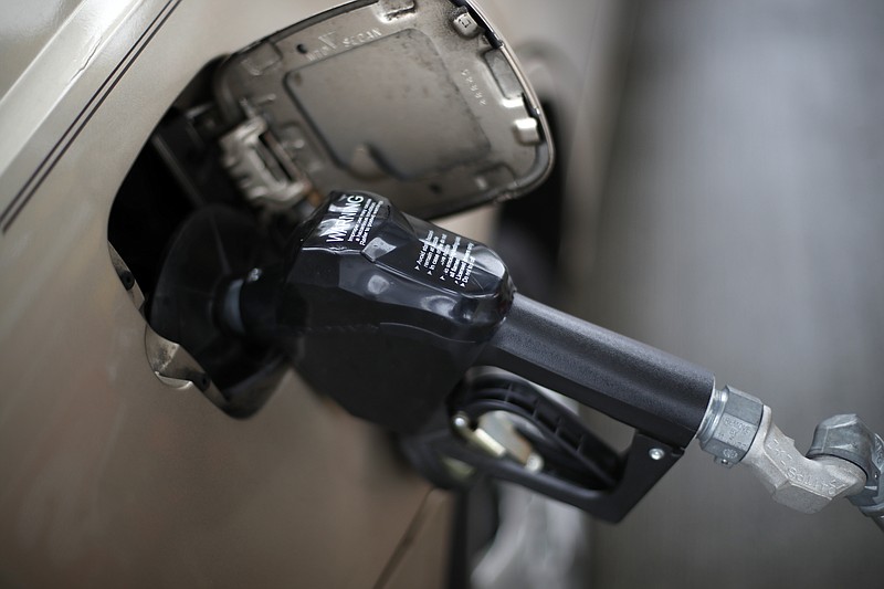 FILE - In this Nov. 16, 2018, file photo, a gas pump nozzle fills up gas in a car at a pump in West Mifflin, Pa. Expect prices to be relatively stable compared to this year, says Tom Kloza global head of energy analysis for the Oil Price Information Service. He said there is a good chance that 2019 will be book-ended by a very weak start for prices and a shaky finish _ with prices around $2.35 to $2.40 a gallon at each end. In between, prices will advance for both crude oil and gasoline.(AP Photo/Gene J. Puskar, File)