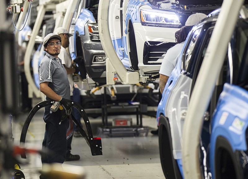 Workers produce vehicles at Volkswagen's lone U.S. plant in Chattanooga, Tenn., on Thursday, Aug. 31, 2017. The plant has begun production of the midsized Atlas SUV alongside the Passat sedan. (AP Photo/Erik Schelzig)