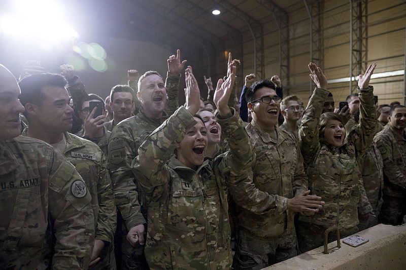 Members of the military cheer as President Donald Trump speaks at a hanger rally at Al Asad Air Base, Iraq, on Wednesday.