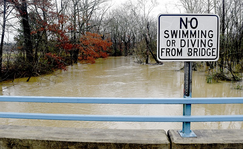 A rain-swollen West Chickamauga Creek flows under the bridge leading in to Camp Jordan in East Ridge.  Overnight rains also caused Mackey Branch to overflow onto East Brainerd Road causes hazardous driving conditions for morning commuters on December 28, 2018.     