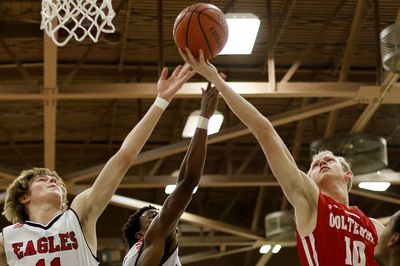 Signal Mountain teammates Malone Howley, left, and Travion Williams, center, and Ooltewah's Jay Howard reach for the ball during a consolation bracket game in the Best of Preps tournament Friday at Chattanooga State.