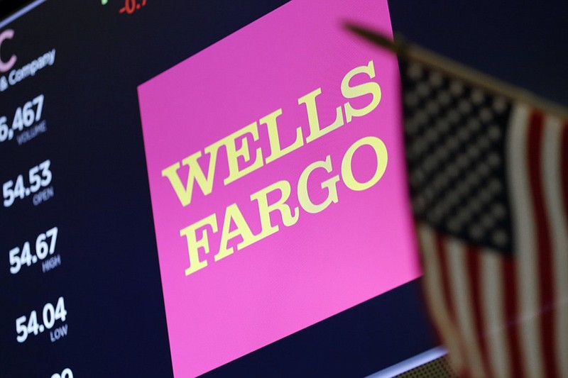 In this May 17, 2018 file photo, the logo for Wells Fargo appears above a trading post on the floor of the New York Stock Exchange. Wells Fargo is paying $575 million as part of deal to resolve investigations by every state into its banking practices, which have included creating phony accounts and using manipulative sales practices. The deal also includes creating teams to review and respond to customer issues about its banking and sales practices. (AP Photo/Richard Drew, File)