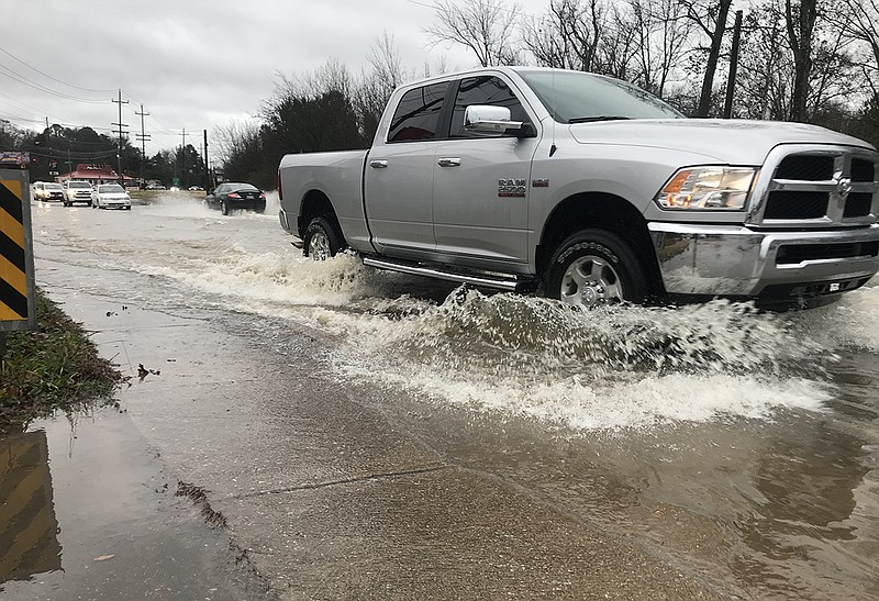 Heavy overnight rains caused Mackey Branch to overflow causes flooding Friday morning on East Brainerd Road.