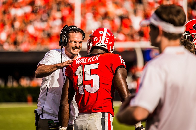 Georgia outside linebackers coach Dan Lanning talks to senior outside linebacker D'Andre Walker during the 38-12 win over Tennessee in late September.