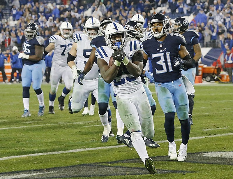 Indianapolis Colts running back Marlon Mack scores a touchdown on an 8-yard run ahead of Tennessee Titans free safety Kevin Byard in the second half of Sunday night's game in Nashville.