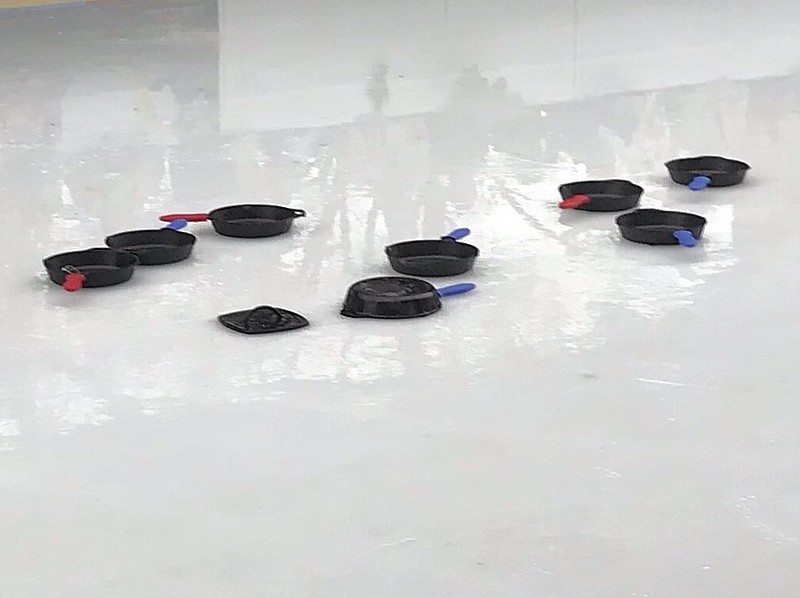 Players slide Lodge cast-iron skillets instead of a stone in Iron Skillet Curling at Ice on the Landing. (Photo contributed from Tom Montague)