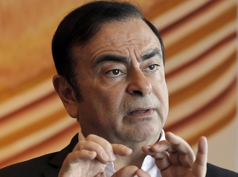 FILE - In this April 20, 2018, file photo, then Nissan Chairman Carlos Ghosn speaks during an interview in Hong Kong. A Japanese news report says former Nissan chairman Ghosn will be detained at least through Jan. 11, 2019. Ghosn, who led Nissan Motor Co. for two decades saving the Japanese automaker from near bankruptcy, was arrested Nov. 19, 2018,  on suspicion of falsifying financial reports.(AP Photo/Kin Cheung, File)