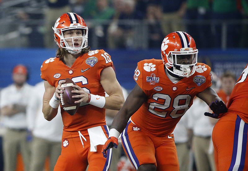 Clemson quarterback Trevor Lawrence (16) drops back to pass as running back Tavien Feaster (28) defends during their NCAA Cotton Bowl semi-final playoff football game against Notre Dame on Saturday, Dec. 29, 2018, in Arlington, Texas. (AP Photo/Michael Ainsworth)