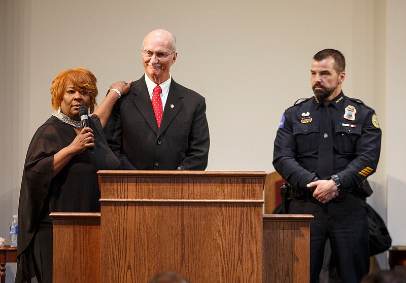 NAACP chapter President Elenora Woods, left, praises Hamilton County Sheriff Jim Hammond, center, alongside Chattanooga Police Chief David Roddy during the NAACP's 77th Annual Jubilee Celebration at Greater Emmanuel Apostolic Church on Tuesday, Jan. 1, 2019, in Chattanooga, Tenn. Jubilee celebrates the emancipation of black slaves by President Abraham Lincoln on Jan. 1, 1863. Eldrin Bell, the first African American police chief of Atlanta, was the celebration's keynote speaker.