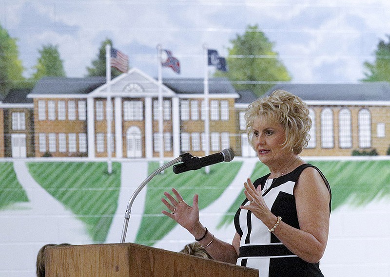 School superintendent Melody Day, seen in front of a mural of the existing Gordon Lee building, speaks during a Chickamauga City School Board meeting held Tuesday, June 2, 2015, at Gordon Lee High School in Chickamauga, Ga., to inform the public about plans for two 1930s-era buildings on campus.