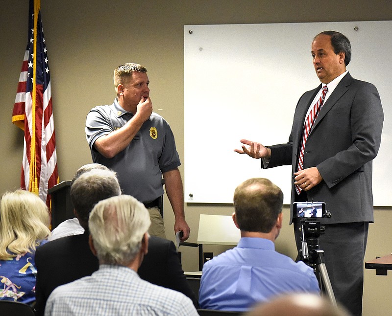 Walker County Commissioner Shannon Whitfield, right, speaks to citizens gathered at the LaFayette-Walker County Public Library while Fire Chief and Emergency Management Director Blake Hodge looks on. Whitfield held the public hearing on a proposed tax increase at the library on Aug. 17, 2017.
