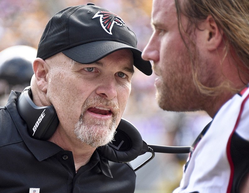 Coach Dan Quinn, left, talks with defensive end Brooks Reed during the Atlanta Falcons' road game against the Pittsburgh Steelers on Oct. 7. Quinn fired his offensive, defensive and special teams coordinators early this week after a 7-9 season that left the team short of the playoffs for the first time in three years.