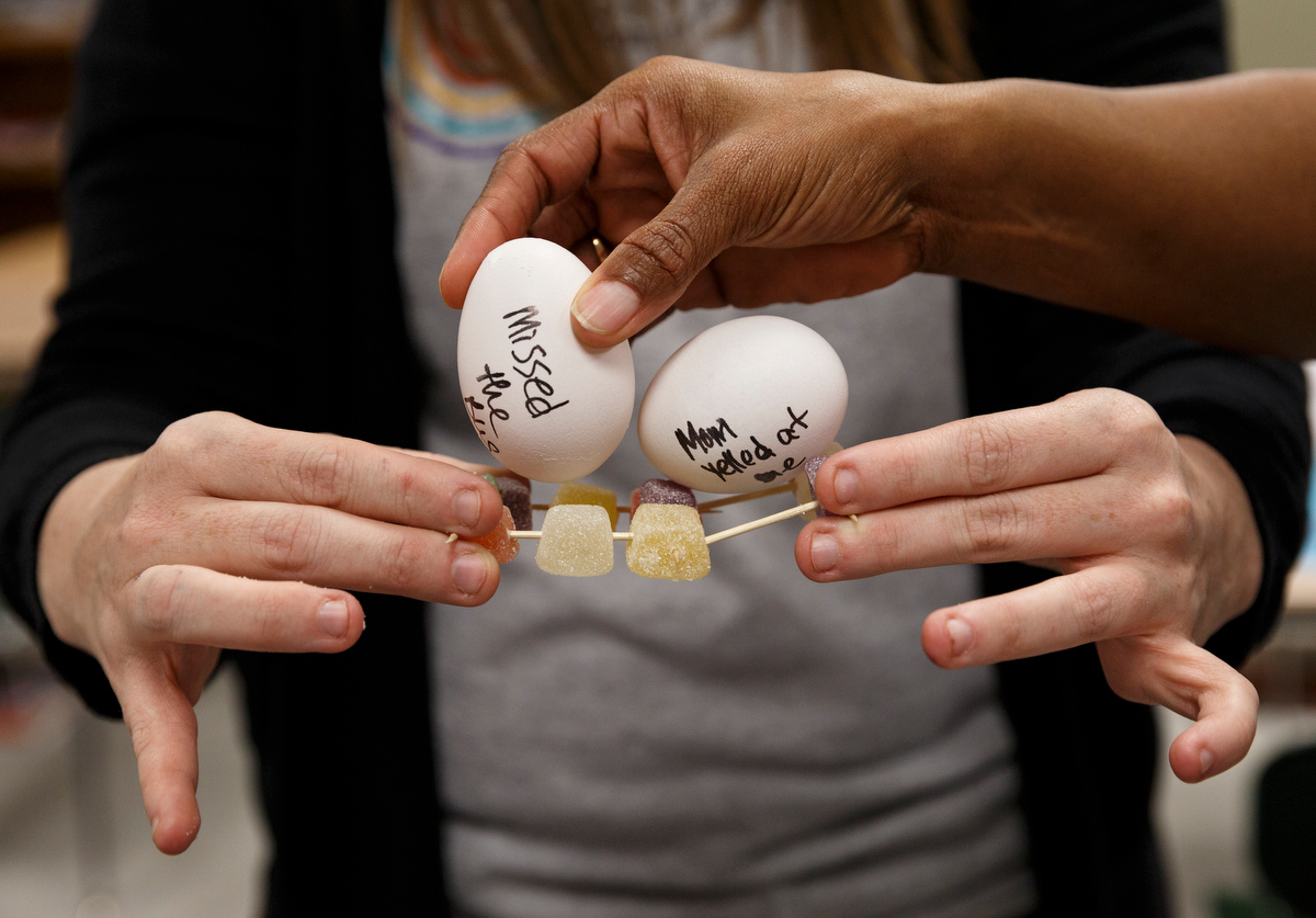 Workshop leaders demonstrate a point about student brain support using eggs during a workshop on managing trauma at Brainerd High School on Friday, Jan. 4, 2019, in Chattanooga, Tenn. The workshop was part of the Hamilton County Opportunity Zone's second Urban Teacher Institute which took place at Brainerd on Friday.