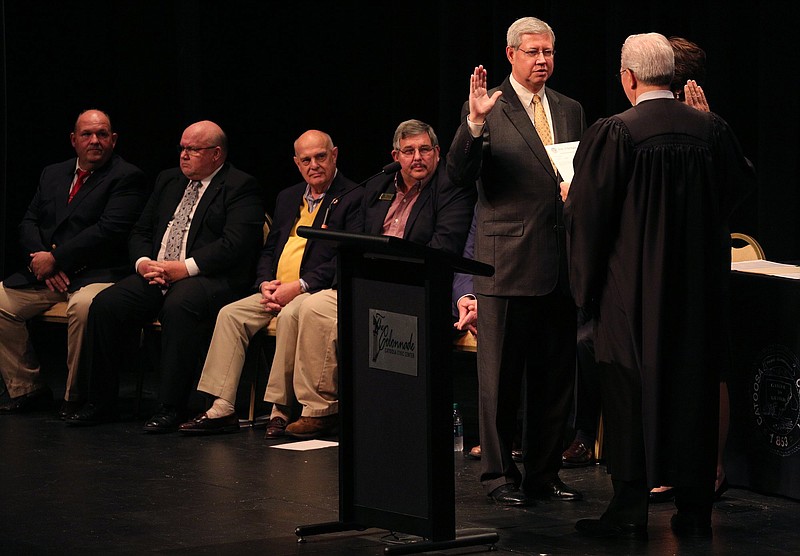 State Court Solicitor Doug Woodruff is sworn in by Probate Judge Jeff Hullender during the Catoosa County elected officials swearing-in program at The Colonnade Jan. 2.