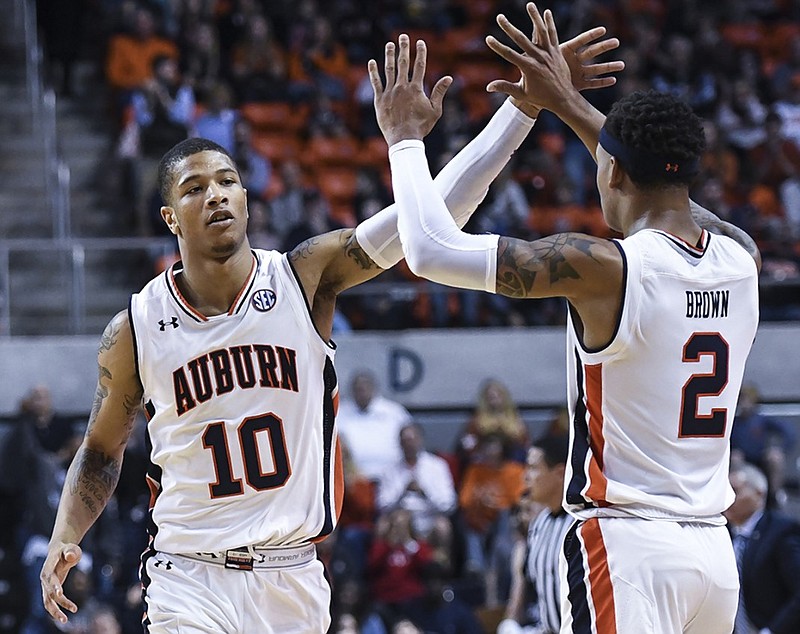 Auburn guards Samir Doughty, left, and Bryce Brown celebrate a score against North Florida during the first half of last Saturday's game in Auburn, Ala. Auburn won 95-49 to complete nonconference play 11-2. The Tigers will return to competition by opening their SEC schedule Wednesday at Ole Miss.