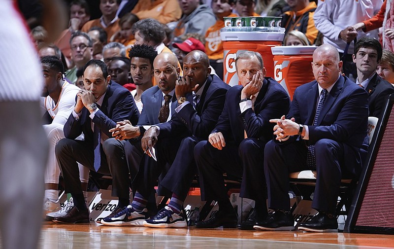 Tennessee men's basketball coach Rick Barnes, second from right, and his staff watch the third-ranked Vols' rout of the Georgia Bulldogs on Saturday at Thompson-Boling Arena in Knoxville.