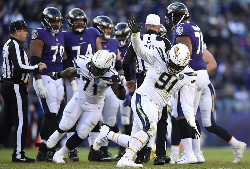 Los Angeles Chargers defensive tackle Justin Jones (91) celebrates after sacking Baltimore Ravens quarterback Lamar Jackson in the second half of Sunday's AFC wild-card playoff game in Baltimore.