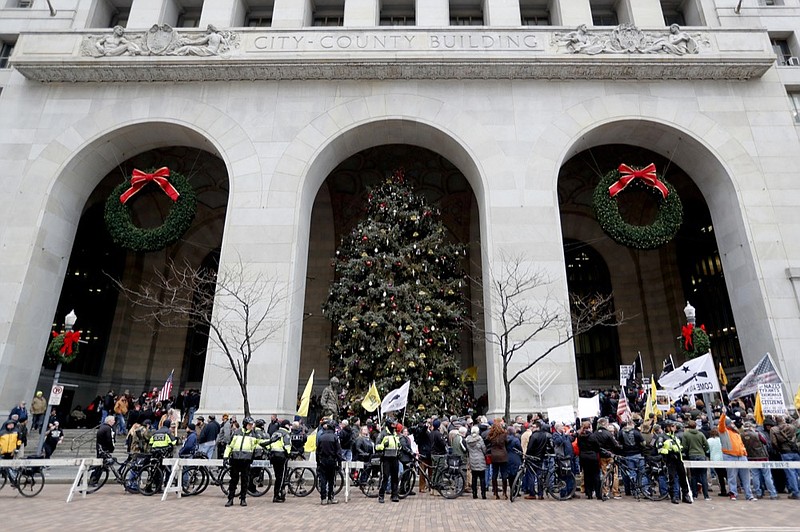 Police block the street in front of the City-County building as protestors gather on Monday, Jan. 7, 2019, in Pittsburgh. The protesters, many openly carrying guns, gathered in downtown Pittsburgh to rally against the city council's proposed restrictions and banning of semi-automatic rifles, certain ammunition and firearms accessories within city limits. (AP Photo/Keith Srakocic)

