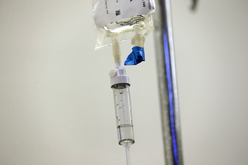 FILE - In this May 25, 2017 file photo, chemotherapy drugs are administered to a patient at a hospital in Chapel Hill, N.C. The U.S. cancer death rate has been falling between 1991 and 2016, and so far there’s little sign the decline is slowing, according to a report released on Tuesday, Jan. 8, 2019. (AP Photo/Gerry Broome)