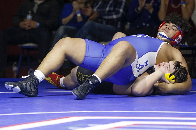 Cleveland's Titus Swafford (blue) wrestles with Bradley Central's Austin McClure during a 285-pound bout at Cleveland High School's Raider Arena on Tuesday, Jan. 8, 2019 in Cleveland, Tenn.