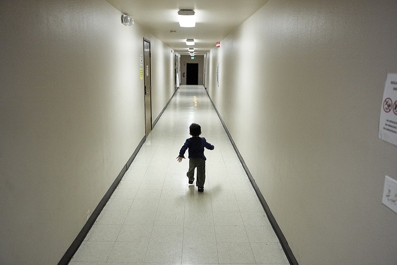 In this Dec. 11, 2018, photo an asylum-seeking boy from Central America runs down a hallway after arriving from an immigration detention center to a shelter in San Diego. Since late October 2016, the U.S. has been releasing asylum-seeking families with little time to arrange travel, which it blames on lack of detention space. To avoid putting penniless families on the streets, charities and advocacy groups from California to Texas are scrambling to provide shelter, food, clothes and help buying bus and plane tickets. (AP Photo/Gregory Bull)

