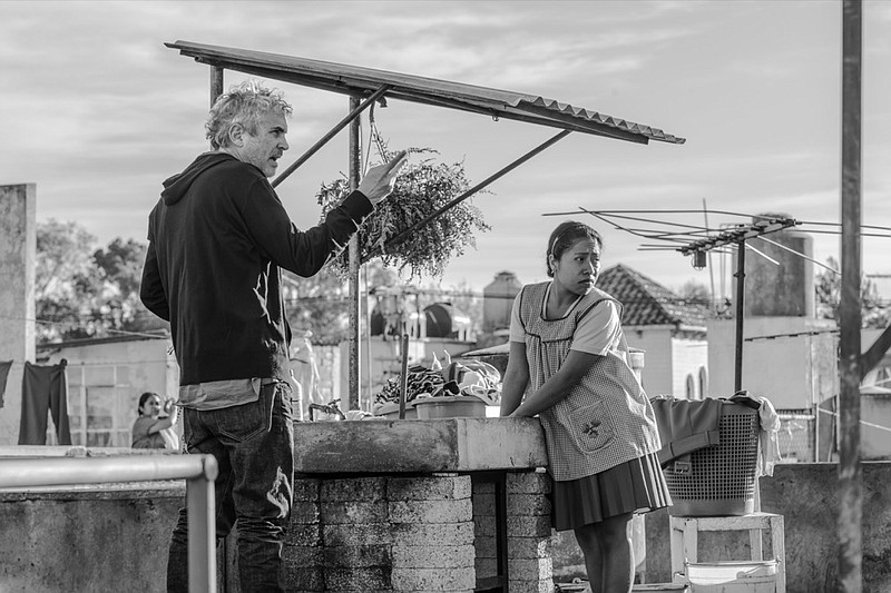 This image released by Netflix shows filmmaker Alfonso Cuaron, left, and actress Yalitza Aparicio on the set of "Roma." Cuaron, Bradley Cooper and Spike Lee are among the nominees for the Director's Guild award for outstanding directorial achievement. The DGA announced its five nominees Tuesday in one of the most closely watched guild awards leading up next month's Academy Awards. (Carlos Somonte/Netflix via AP)

