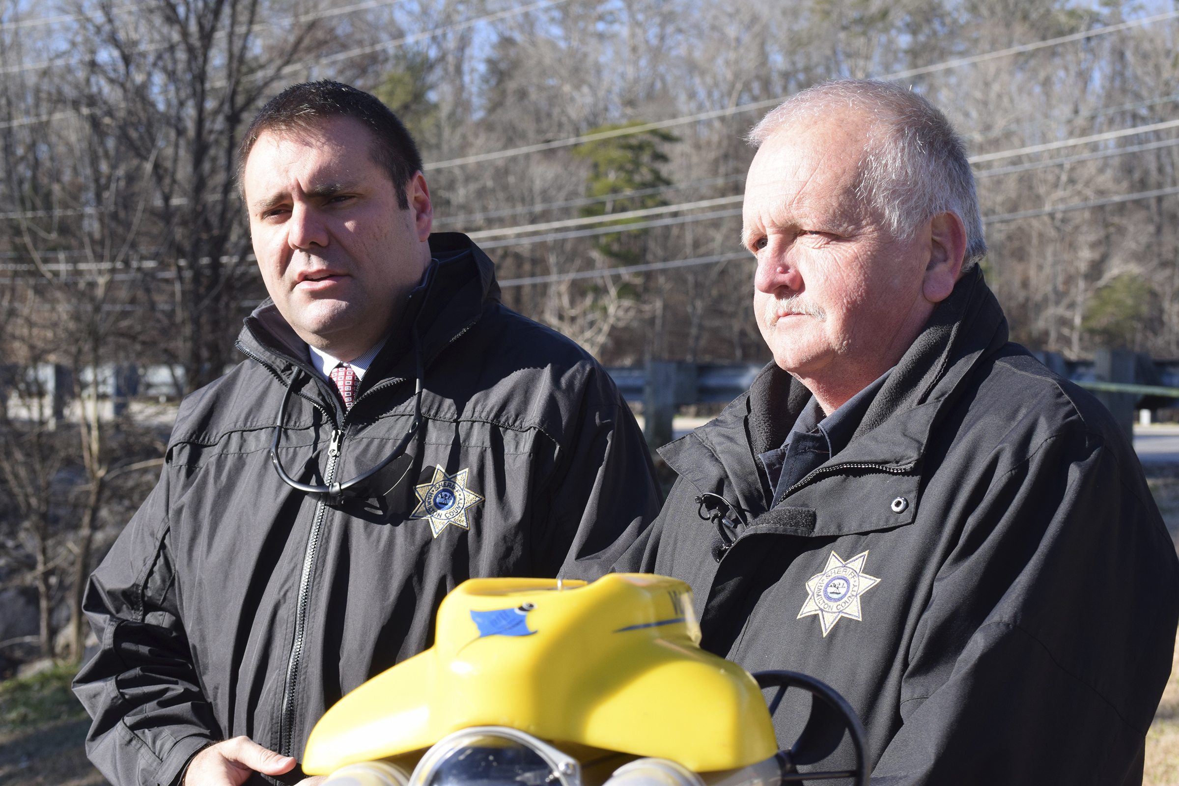 Hamilton County Sheriff's Office spokesman Matt Lea and John Scruggs, one of 10 divers on the department's forensic dive team, talk about challenges and equipment being used to search on Chickamauga Lake for a missing pilot and parts of his plane following a crash on Monday. / Staff Photo by Ben Benton