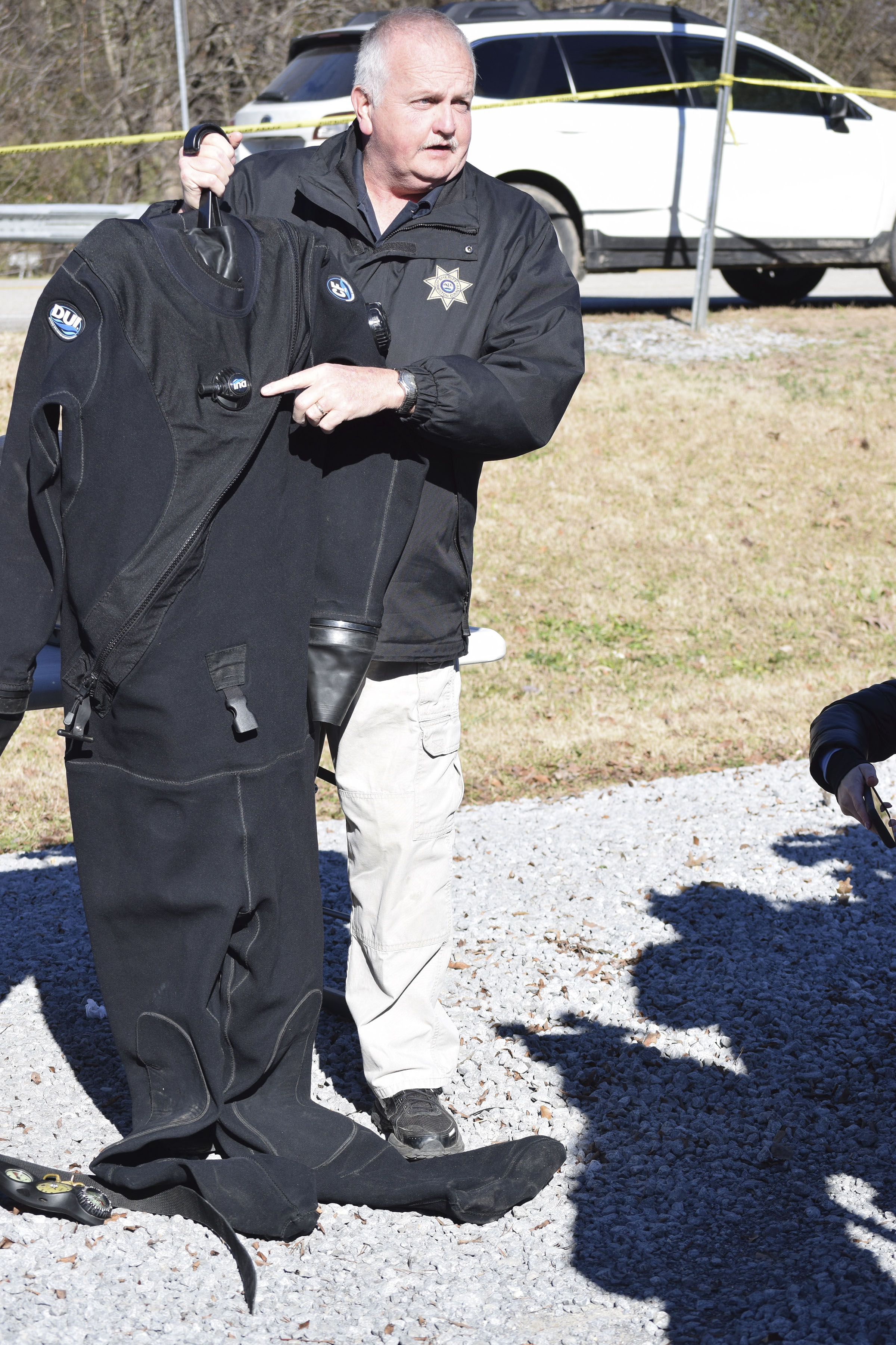 Staff photo by Ben Benton /
John Scruggs, one of 10 divers on the Hamilton County Sheriff's Office forensic dive team, describes how dry suits work that are being used by divers in the search for a missing pilot and his plane on Chickamauga Lake.