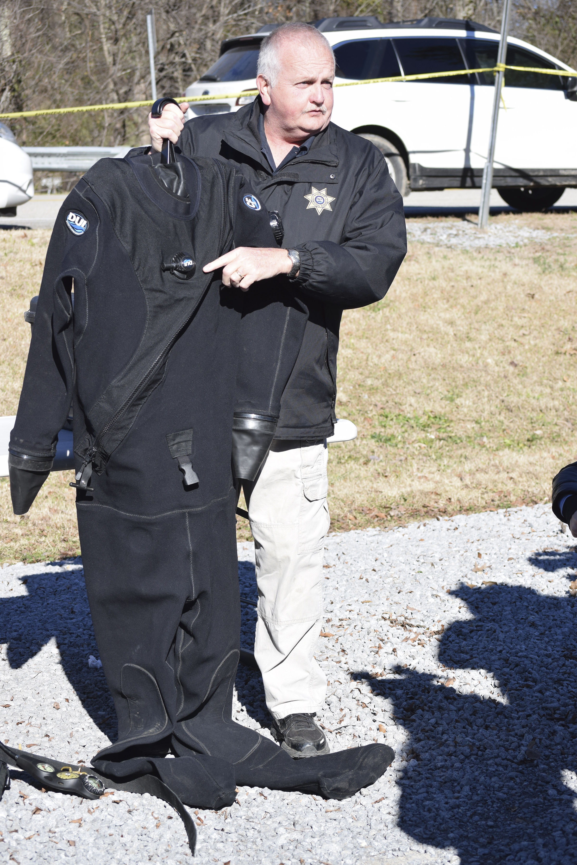 Staff photo by Ben Benton /
John Scruggs, one of 10 divers on the Hamilton County Sheriff's Office forensic dive team, describes how dry suits work that are being used by divers in the search for a missing pilot and his plane on Chickamauga Lake.