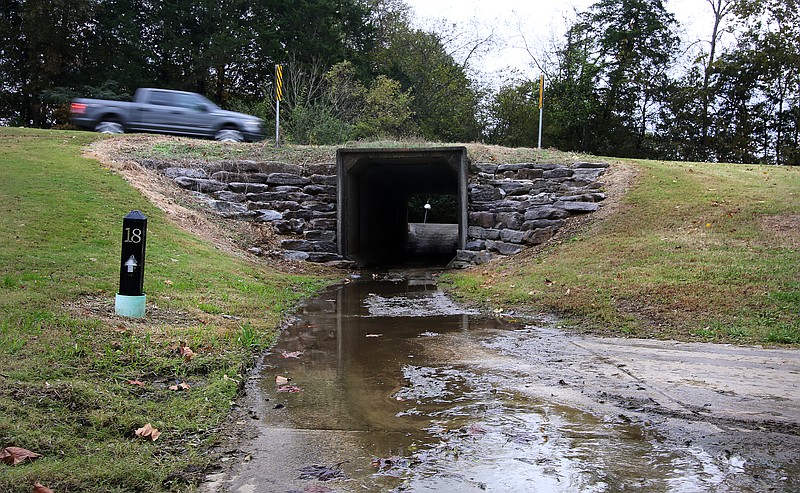 Water, which appears to have sewage mixed in, leaks onto the path of the Champions Golf Course near the Snow Hill pump station in the 7600 block of Snow Hill Road Friday, November 2, 2018 in Ooltewah, Tennessee. Water and Wastewater Treatment Authority workers were clearing a stand pipe at the Snow Hill pump station Friday after clogs caused a massive sewer overflow last weekend.