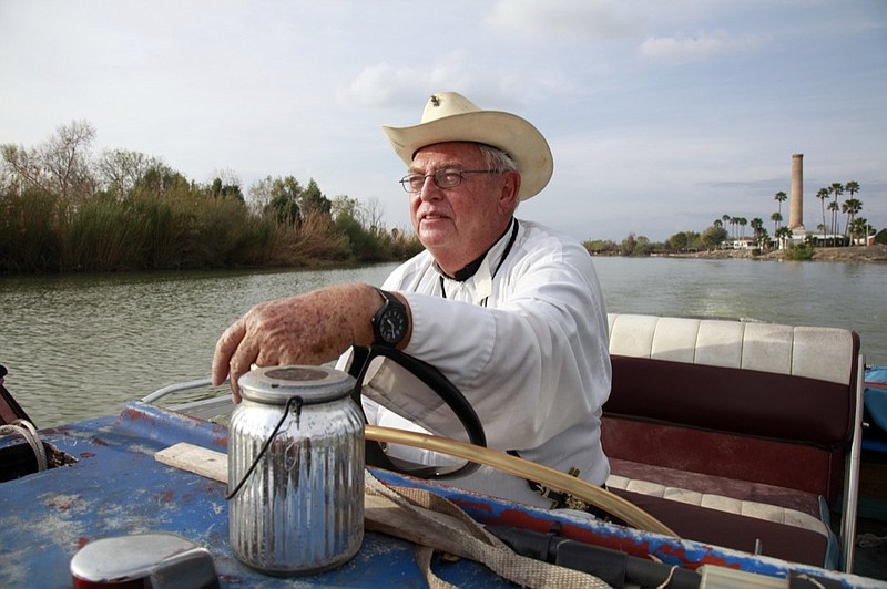 In this Tuesday, Jan. 8, 2019 photo, father Roy Snipes, pastor of the La Lomita Chapel, shows Associated Press journalists the land on either side of the Rio Grande at the US-Mexico border in Mission, Texas. Portions of Father Snipes' church land in Mission could be seized by the federal government to construct additional border wall and fence lines. Rather than surrender their land to the federal government, some property owners on the Texas border are digging in to fight President Donald Trump's border wall. They are rejecting buyout offers and preparing to battle the administration in court. Trump is scheduled to travel to the border Thursday to make the case for his $5.7 billion wall. (AP Photo/John L. Mone)

