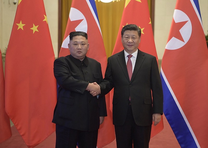 In this Tuesday, Jan. 8, 2019, photo released by China's Xinhua News Agency, North Korean leader Kim Jong Un, left, and Chinese President Xi Jinping shake hands as they pose for a photo before talks at the Great Hall of the People in Beijing. A special train believed to be carrying Kim Jong Un departed Beijing on Wednesday after a two-day visit by the North Korean leader to the Chinese capital. (Li Xueren/Xinhua via AP)

