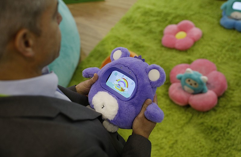 A man holds a Woobo talking robot at the Woobo booth at CES International, Wednesday, Jan. 9, 2019, in Las Vegas. (AP Photo/John Locher)