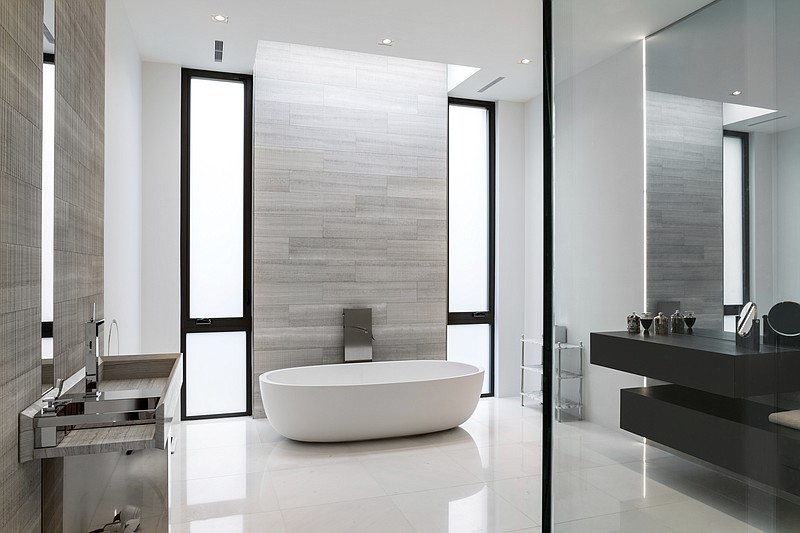 This photo shows the contrast of painted walls and tiled areas, as seen in this McLean, Va., master bathroom, which can make the tiles a more noticeable focal point. In assessing trends for the new year in bath design, interior designer Julia Walter says many homeowners are only tiling parts of their master bathrooms. (Angie Seckinger/Boffi Georgetown via AP)