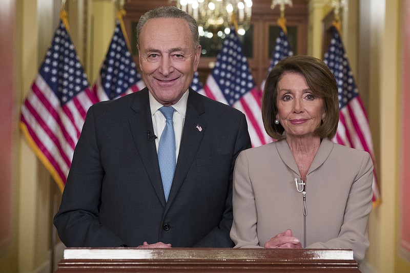 Senate Minority Leader Chuck Schumer, of New York, and House Speaker Nancy Pelosi, of California, pose for photographers after speaking on Capitol Hill in response President Donald Trump's address on Tuesday Washington. (AP Photo/Alex Brandon)
