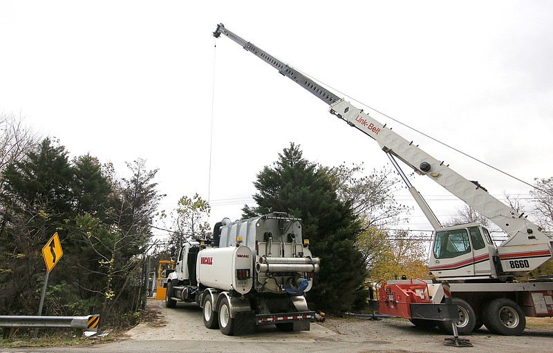 Water and Wastewater Treatment Authority workers clear a stand pipe at the Snow Hill pump station in November as part of ongoing maintenance in the utility's sewage lines.