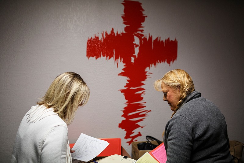 Chattanooga Housing Authority section 8 voucher director Tammie Carpenter, left, and voucher worker Tina Payne prepare for a meeting with residents at the Chatt City Suites extended-stay motel on Friday, Jan. 11, 2019, in Chattanooga, Tenn. Chatt City Suites residents have been told that they must leave the hotel by January 15 to accommodate renovations by an unknown developer. The Chattanooga Housing Authority was on site Friday to meet with residents about the next steps in finding replacement housing.